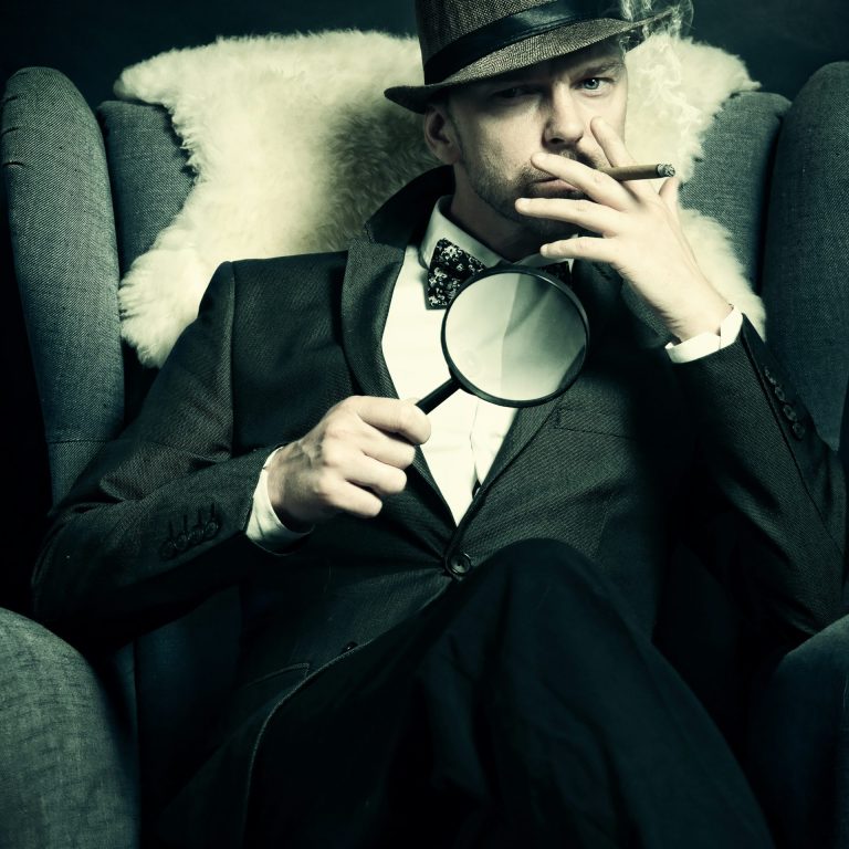 A private detective holding a magnifying glass.