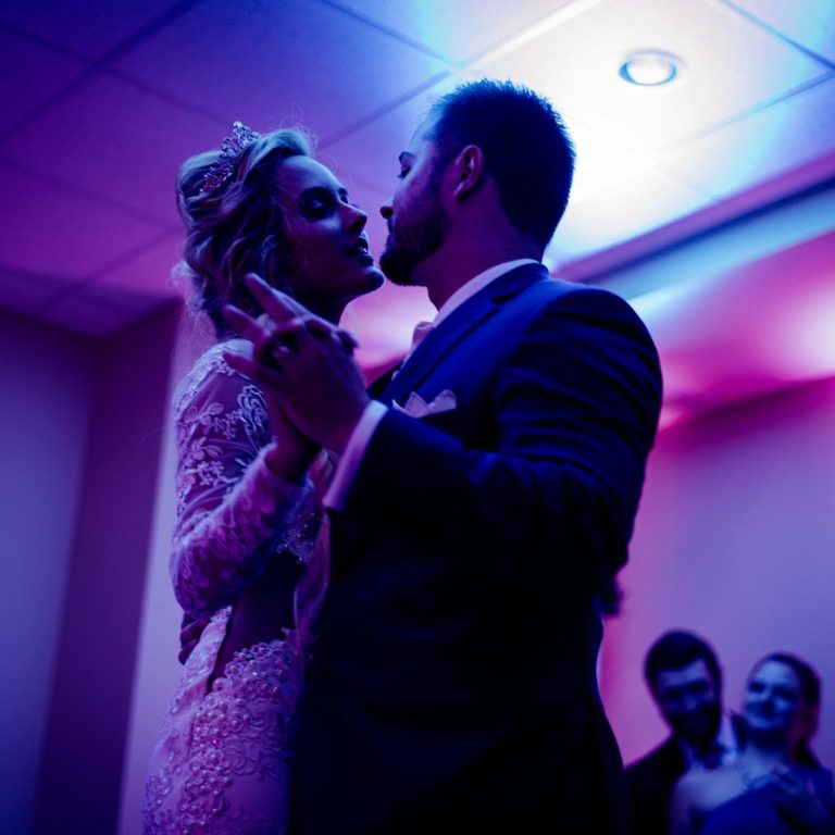 A man and a woman dance in a nightclub.